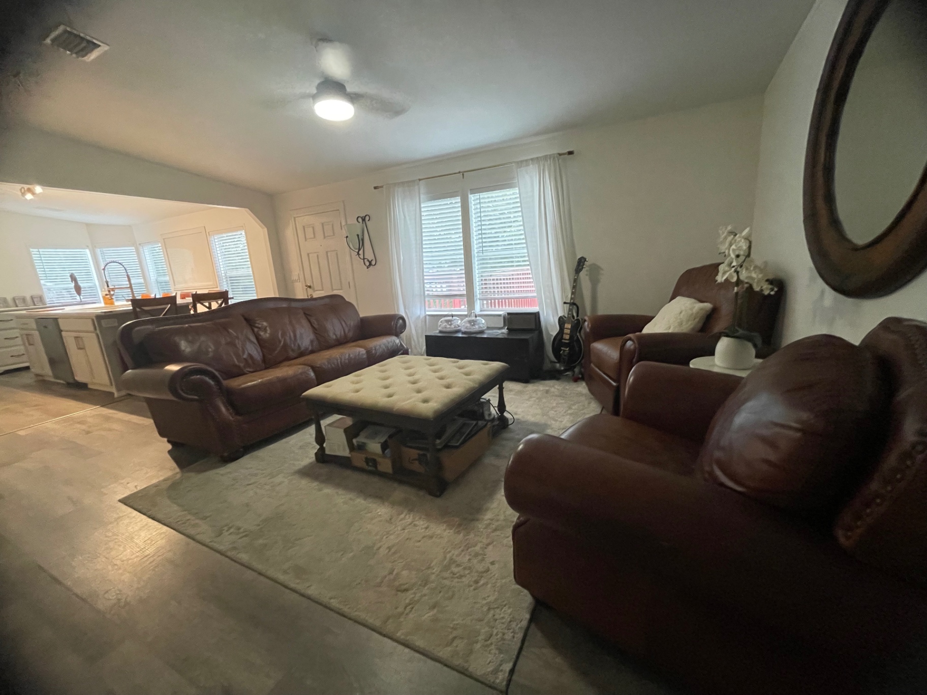 Living room with leather sofas and warm natural light